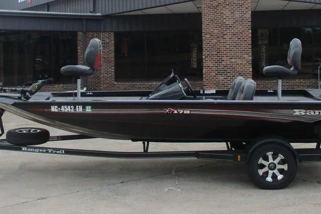 The Image of 2018 Ranger RT178 fishing boat on trailer, parked outside a brick building. - 0