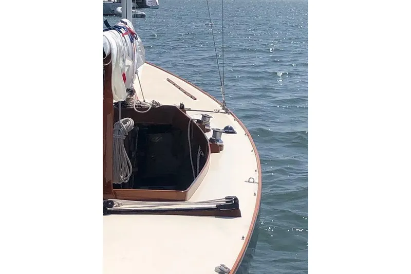 Slide: The Image of 1963 Cape Cod Shipbuilding Shields sailboat on calm water, showcasing deck and rigging. - 13