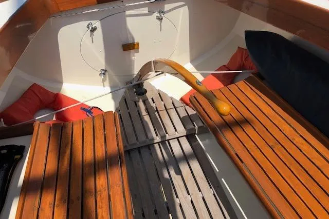 Slide: The Image of 1963 Cape Cod Shipbuilding Shields sailboat cockpit with wooden seats and tiller. - 18