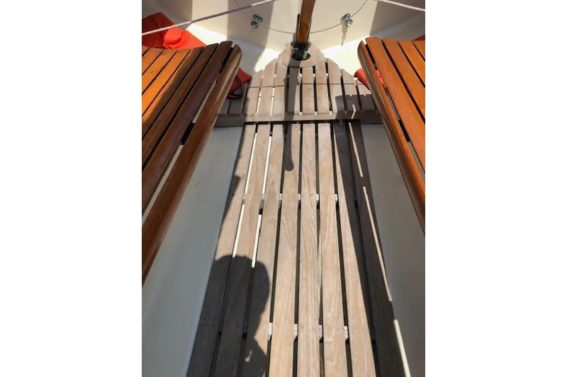 Slide: The Image of Interior view of a 1963 Cape Cod Shipbuilding Shields sailboat with wooden seating and flooring. - 25