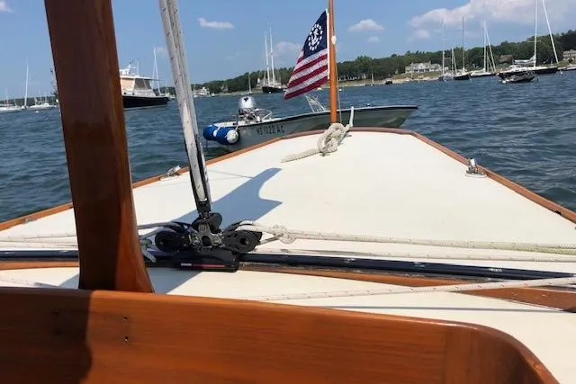Slide: The Image of Sailing on a 1963 Cape Cod Shipbuilding Shields boat with American flag in harbor. - 26