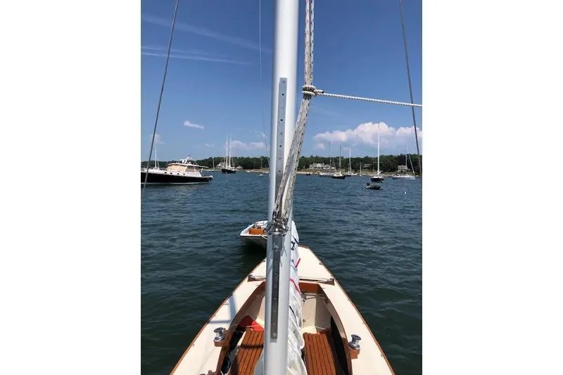 Slide: The Image of Sailboat on calm waters, Cape Cod Shipbuilding Shields model, 1963, with scenic harbor view. - 27
