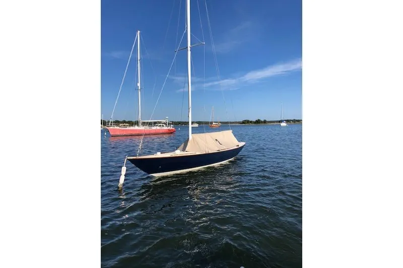Slide: The Image of 1963 Cape Cod Shipbuilding Shields sailboat moored on calm water under clear blue sky. - 6
