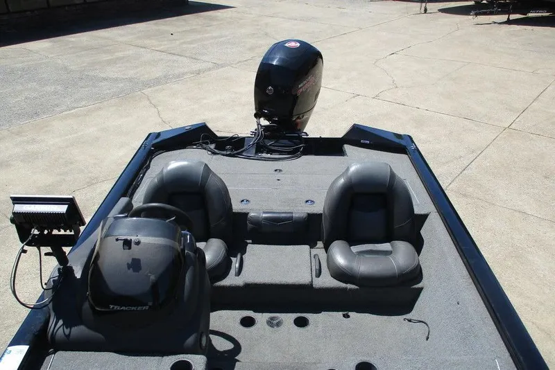 Slide: The Image of 2019 Tracker Pro Team 195 TXW boat interior with seating and motor. - 4