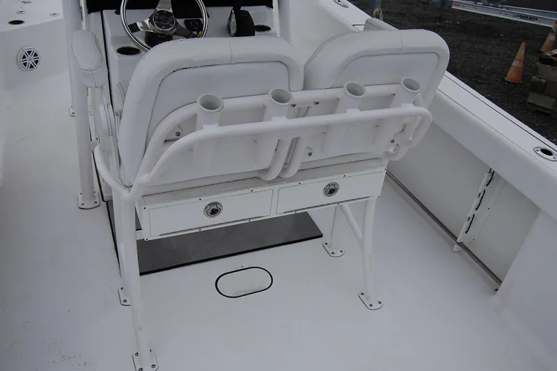 Slide: The Image of 2023 Sportsman Open 242 Center Console boat interior with dual seats and storage compartments. - 7