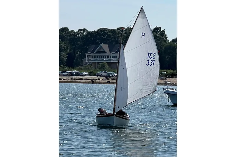 Slide: The Image of Sailboat "Edey & Duff Doughdish 1981" on water near shoreline with house in background. - 2
