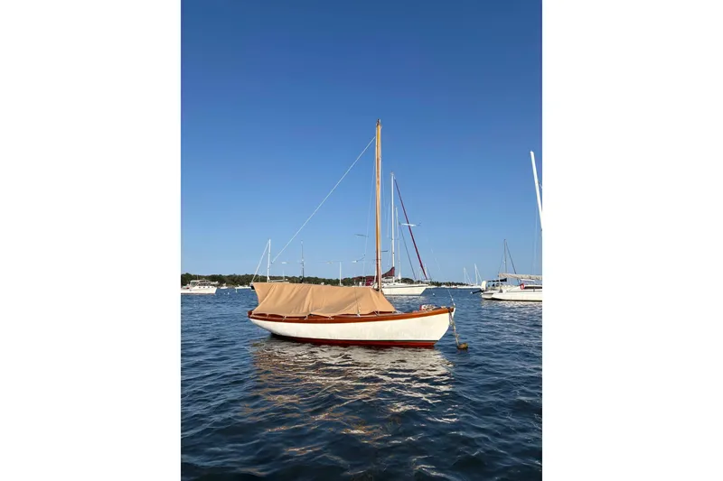 Slide: The Image of 1981 Edey & Duff Doughdish sailboat moored on calm water under clear blue sky. - 4