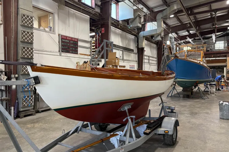 Slide: The Image of 1981 Edey & Duff Doughdish sailboat in a workshop, displayed on a trailer. - 9