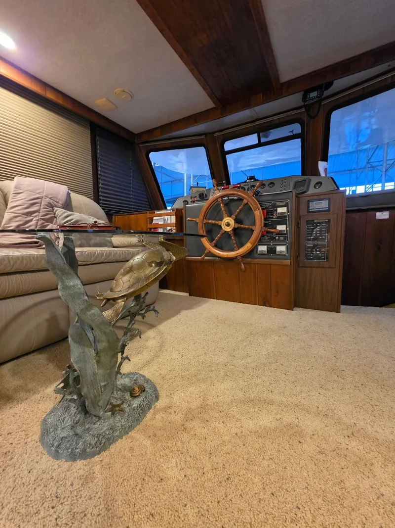 Slide: The Image of Interior of a 1994 Gibson 47 Executive yacht with steering wheel and sofa. - 11