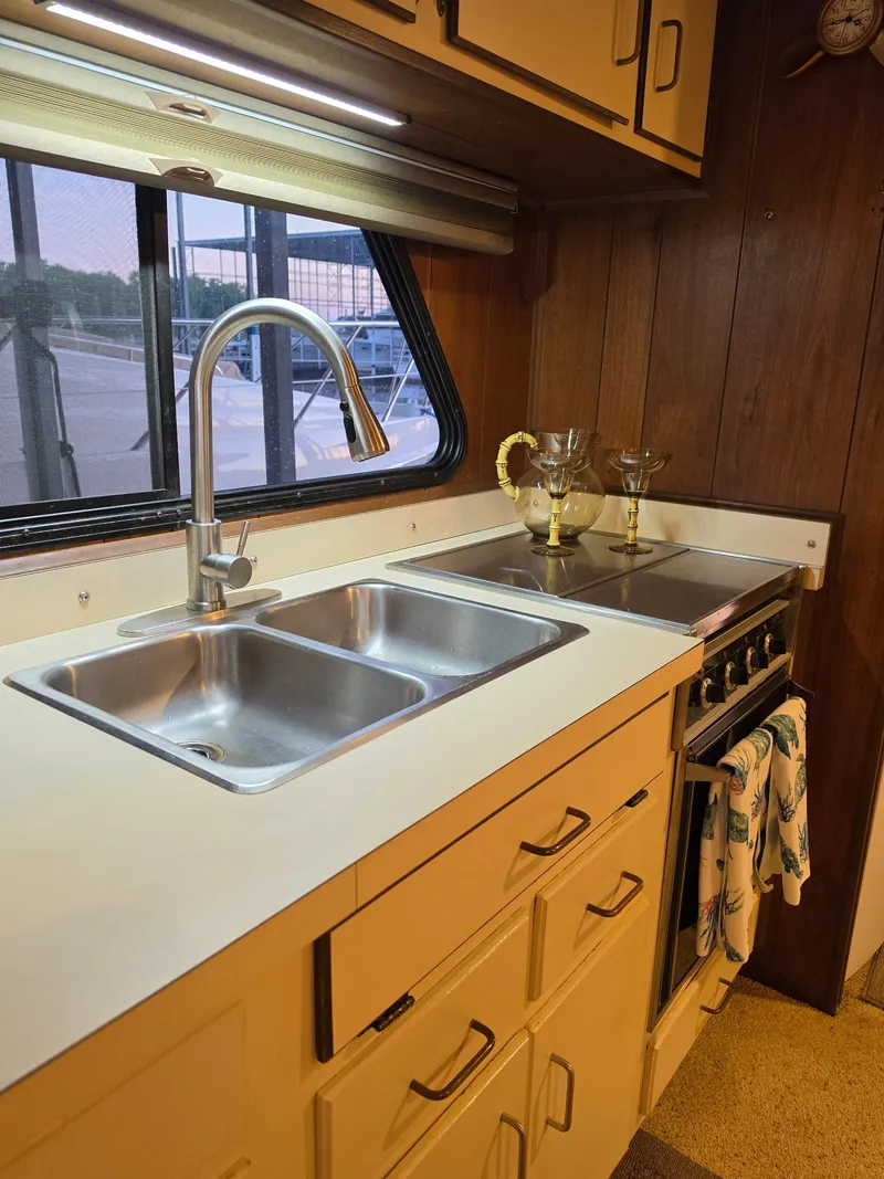 Slide: The Image of Kitchen area in a 1994 Gibson 47 Executive boat. - 14