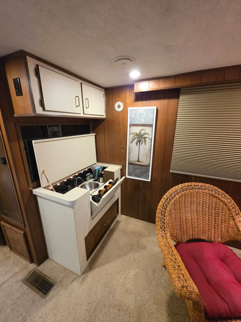 Slide: The Image of Interior of a 1994 Gibson 47 Executive with bar and wicker chair. - 15