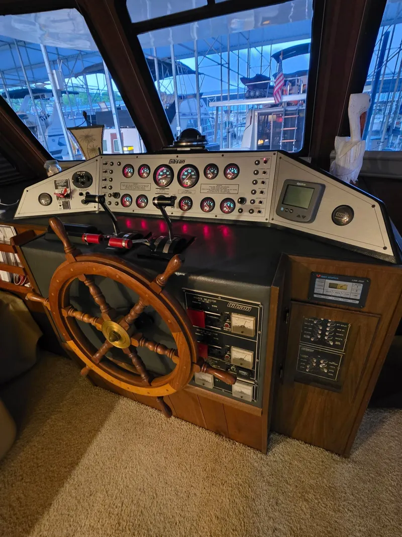 Slide: The Image of Helm of a 1994 Gibson 47 Executive boat with wooden steering wheel. - 16