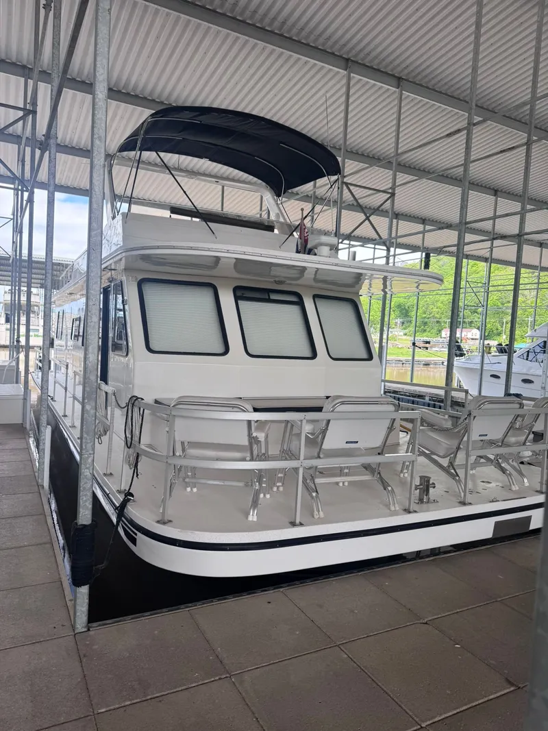 Slide: The Image of 1994 Gibson 47 Executive houseboat docked in marina. - 17