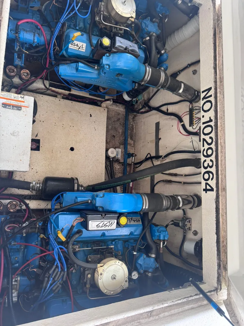 Slide: The Image of Engine compartment of a 1994 Gibson 47 Executive boat with blue engines. - 24