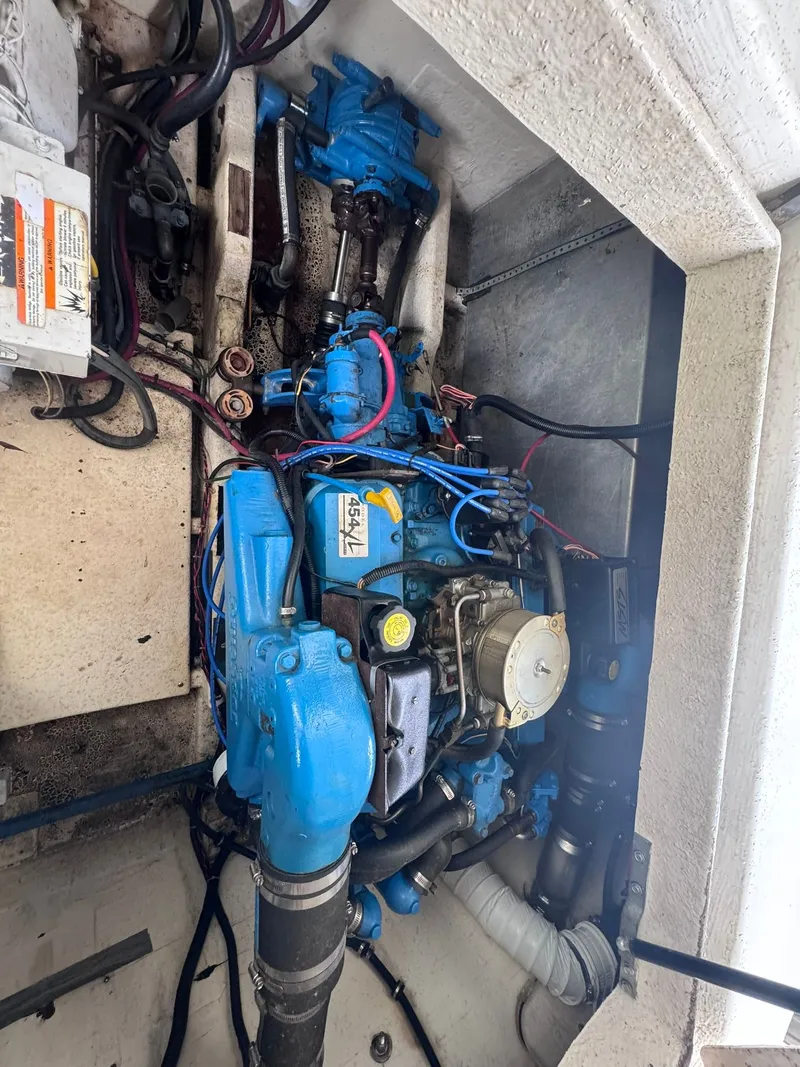 Slide: The Image of Engine compartment of a 1994 Gibson 47 Executive boat with blue engine. - 27
