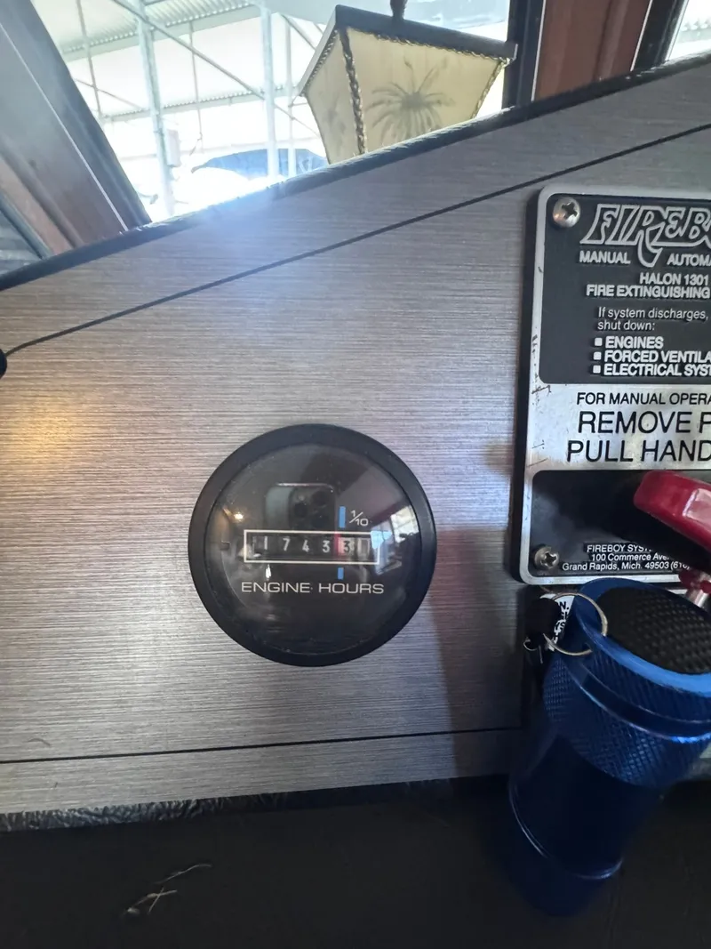 Slide: The Image of Gibson 47 Executive 1994 engine hours gauge and fire extinguisher. - 32