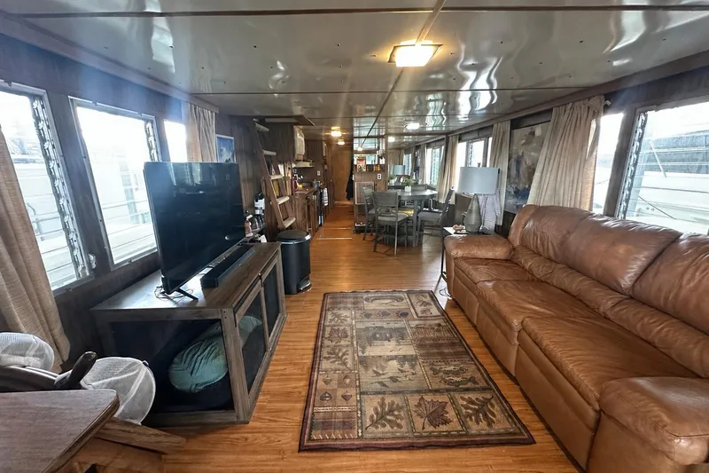 Slide: The Image of Interior of a 1980 Lazy Days 14x59 houseboat with cozy living area and large windows. - 2