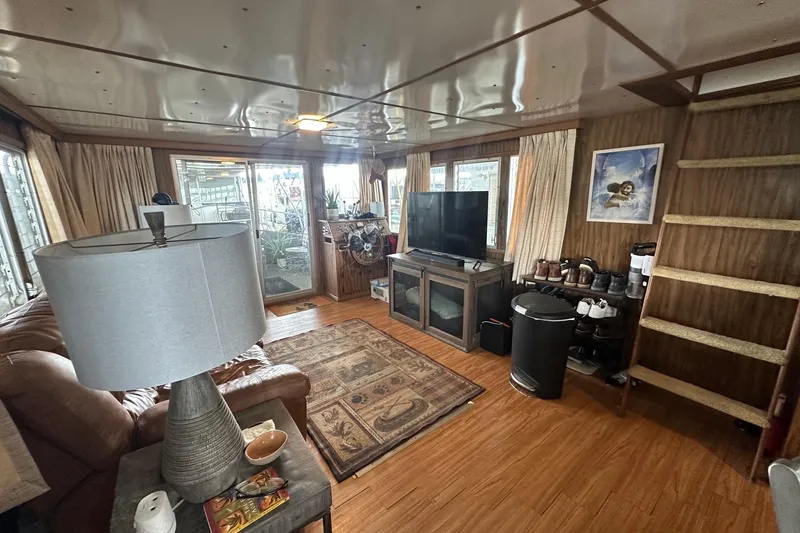 Slide: The Image of Cozy 1980 Lazy Days 14x59 houseboat interior with wood paneling and modern amenities. - 3