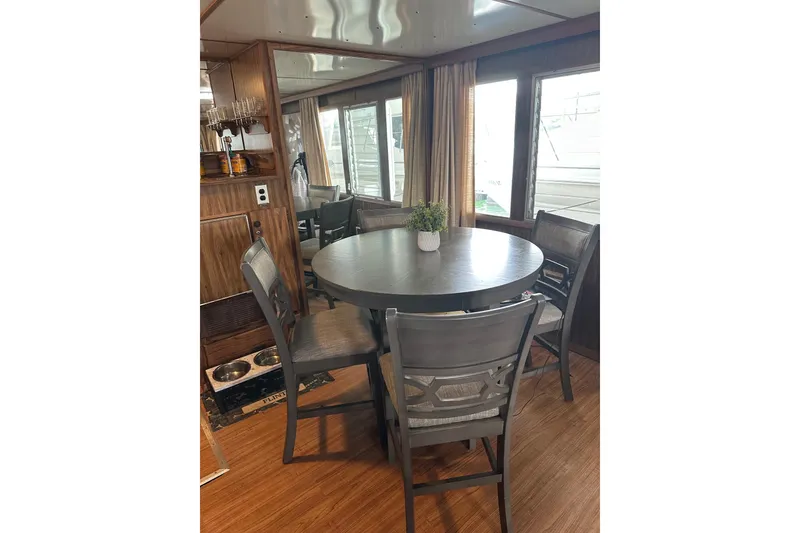 Slide: The Image of Cozy dining area in 1980 Lazy Days houseboat with round table and chairs. - 5