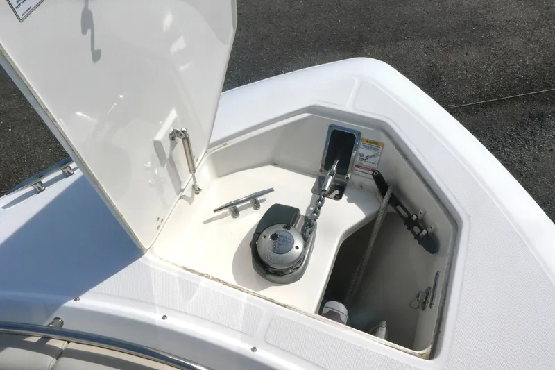 Slide: The Image of Anchor compartment of 2020 Boston Whaler 330 Outrage boat, featuring chain and cleat. - 13