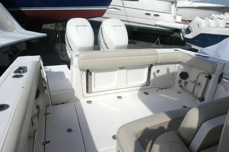 Slide: The Image of 2020 Boston Whaler 330 Outrage boat interior with dual Mercury engines. - 3