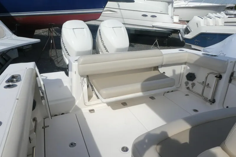 Slide: The Image of 2020 Boston Whaler 330 Outrage boat interior with seating and twin Mercury engines. - 4