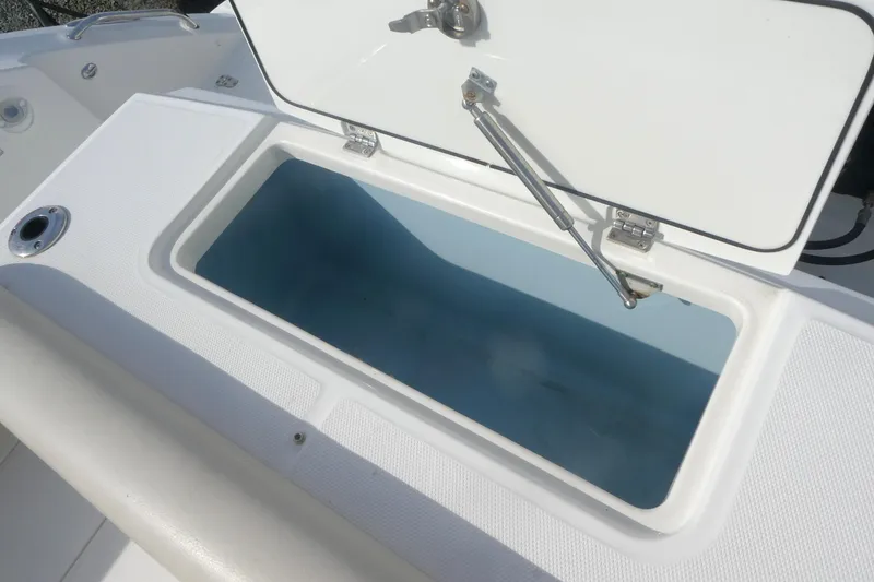 Slide: The Image of Open storage compartment on a 2020 Boston Whaler 330 Outrage boat. - 5