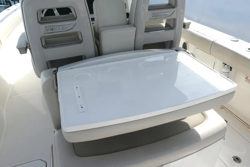 Slide: The Image of 2020 Boston Whaler 330 Outrage boat seating area with foldable table. - 7