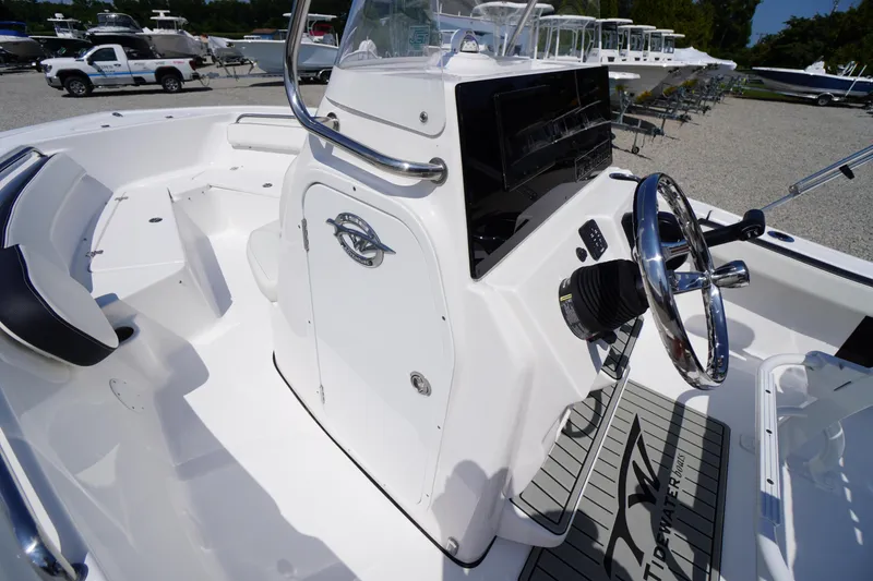 Slide: The Image of 2025 Tidewater 198 CC Adventure boat interior with steering wheel and seating. - 16