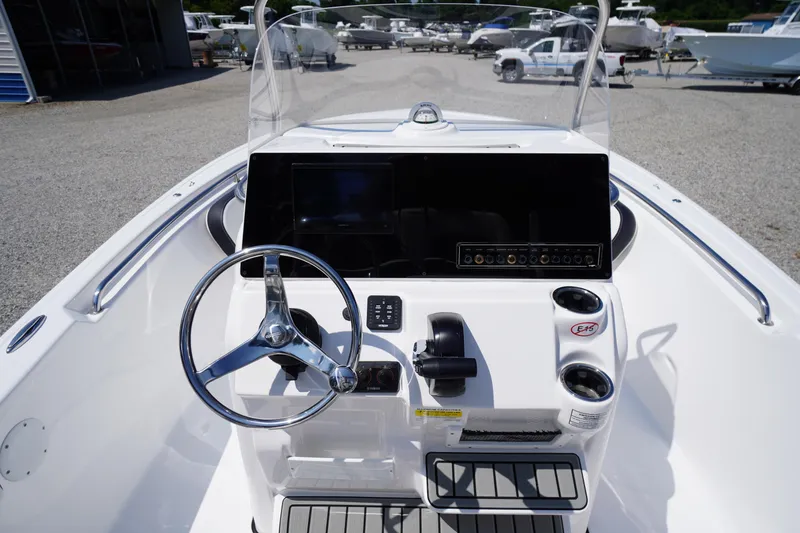 Slide: The Image of 2025 Tidewater 198 CC Adventure boat dashboard with steering wheel and controls. - 20