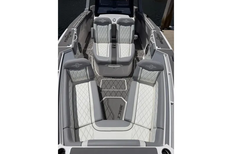 Slide: The Image of 2024 Fountain 38 SCX boat interior with luxurious gray and white quilted seating. - 10