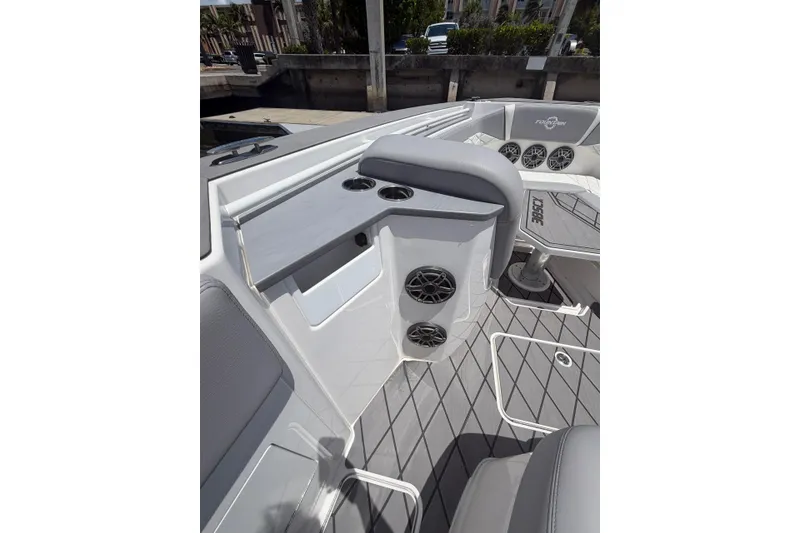 Slide: The Image of 2024 Fountain 38 SCX boat interior with seating, cup holders, and speakers. - 17