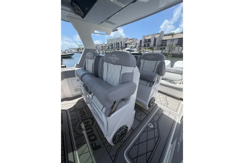 Slide: The Image of 2024 Fountain 38 SCX boat interior with luxurious seating and waterfront view. - 18