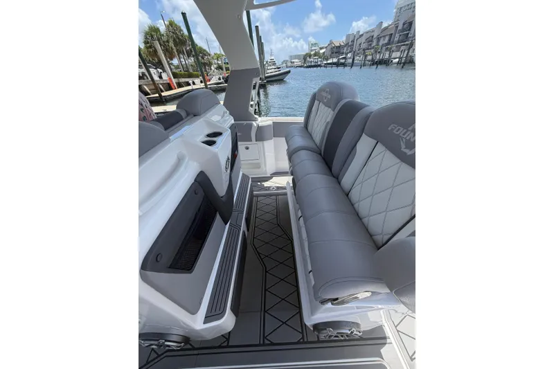 Slide: The Image of 2024 Fountain 38 SCX boat interior with luxurious seating and waterfront view. - 19