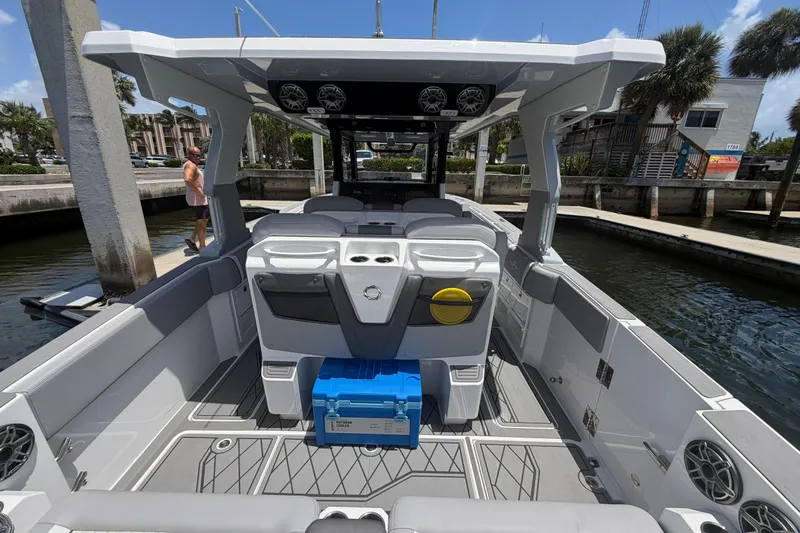 Slide: The Image of 2024 Fountain 38 SCX boat interior with seating, speakers, and storage compartments. - 24