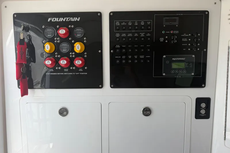 Slide: The Image of Control panel of 2024 Fountain 38 SCX boat with switches and Mastervolt display. - 25