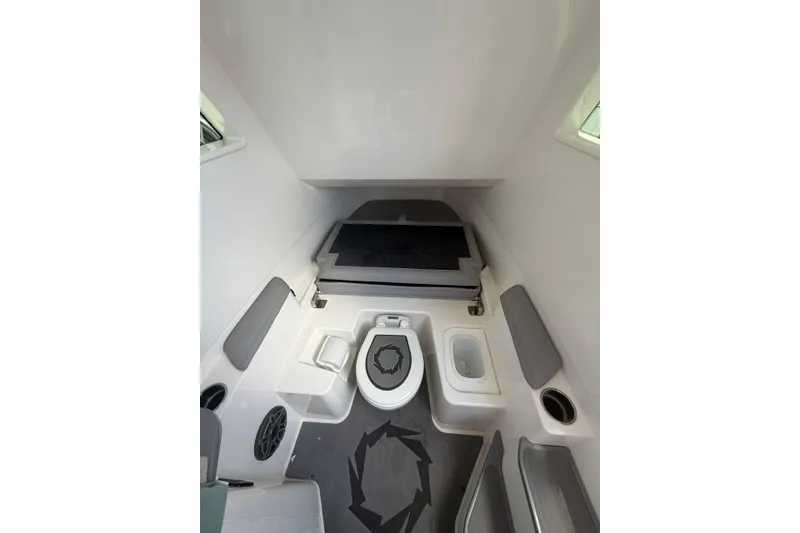 Slide: The Image of Interior cabin of 2024 Fountain 38 SCX boat, featuring seating and amenities. - 27