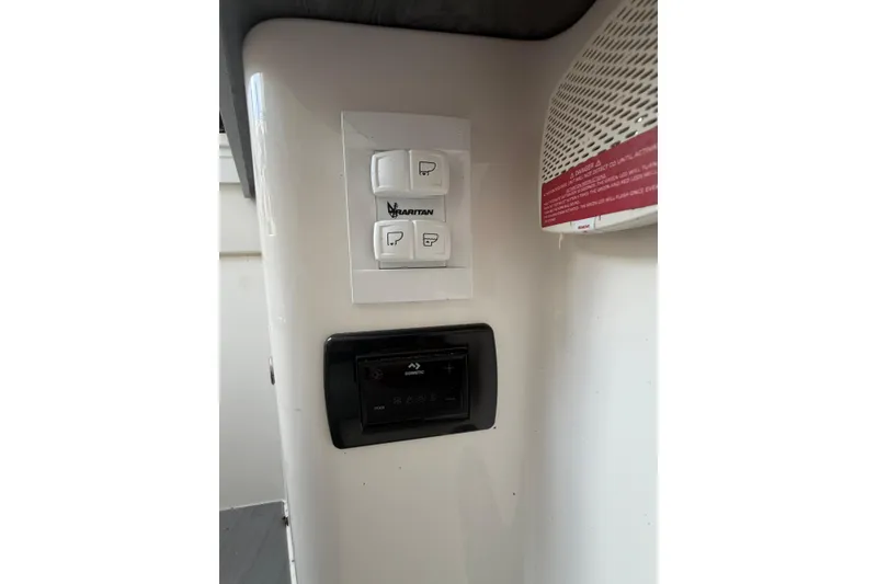 Slide: The Image of Control panel on 2024 Fountain 38 SCX boat interior, featuring Raritan and Dometic switches. - 29