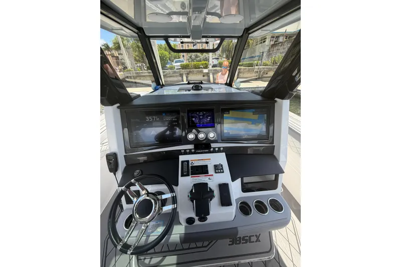 Slide: The Image of 2024 Fountain 38 SCX boat dashboard with advanced navigation displays and controls. - 3