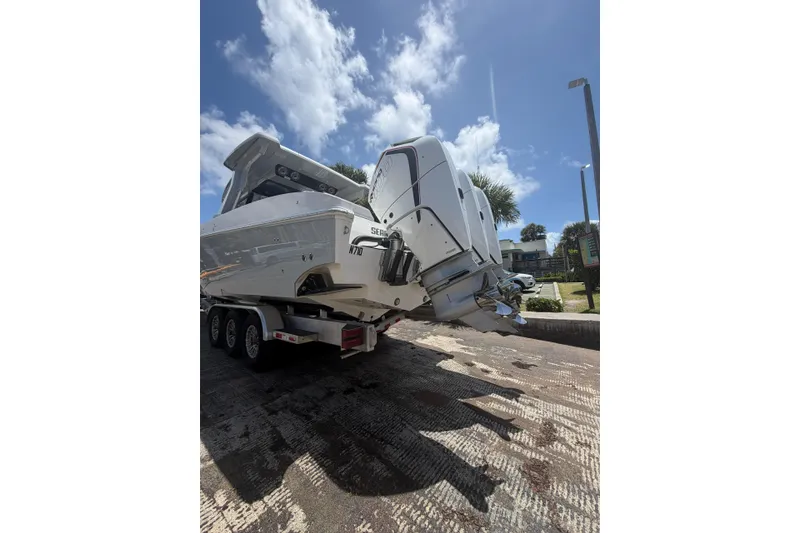 Slide: The Image of 2024 Fountain 38 SCX boat on trailer under clear blue sky. - 33