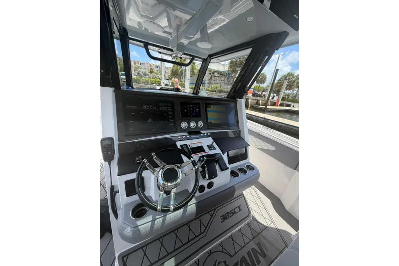 Slide: The Image of 2024 Fountain 38 SCX boat dashboard with modern controls and navigation screens. - 5