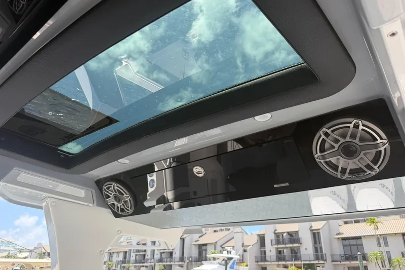 Slide: The Image of 2024 Fountain 38 SCX boat interior with speakers and sunroof, showcasing modern design. - 6