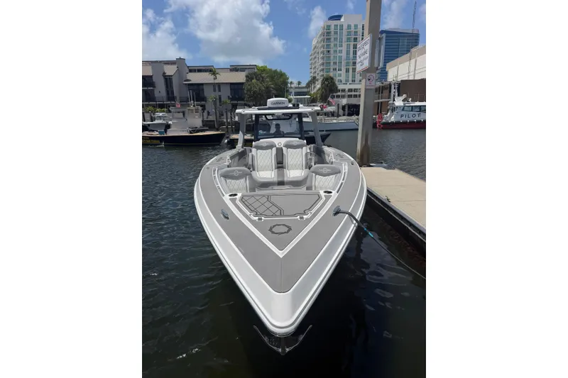 Slide: The Image of 2024 Fountain 38 SCX boat docked in a marina, showcasing sleek design and modern features. - 8
