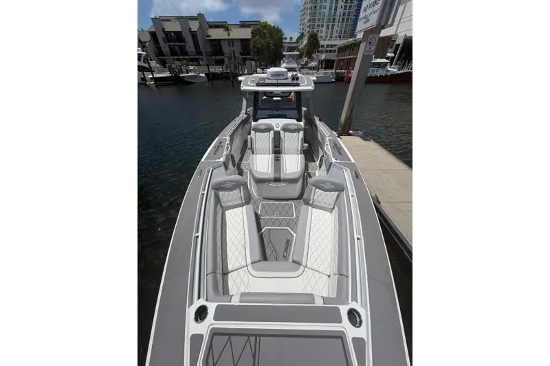 Slide: The Image of 2024 Fountain 38 SCX boat docked, featuring sleek design and luxurious seating. - 9