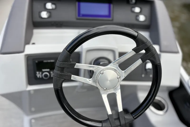 Slide: The Image of Steering wheel of 2022 Bennington Saltwater Series boat, featuring modern dashboard controls. - 4