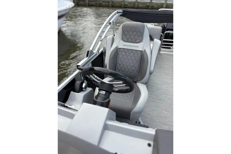 Slide: The Image of 2022 Bennington Saltwater Series boat interior with luxury seating and steering wheel. - 5
