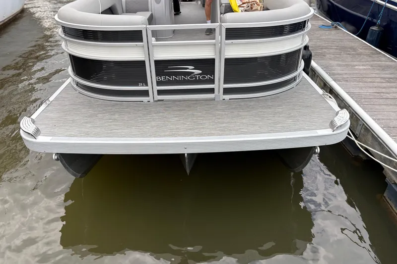 Slide: The Image of 2022 Bennington Saltwater Series pontoon boat docked at marina. - 6