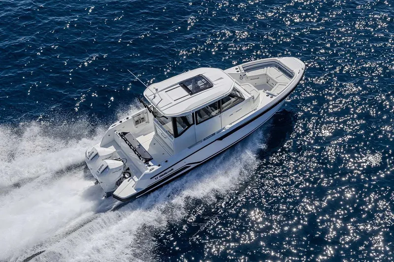 The Image of 2026 Wellcraft 28 Explorer cruising on sparkling blue ocean waters. - 0
