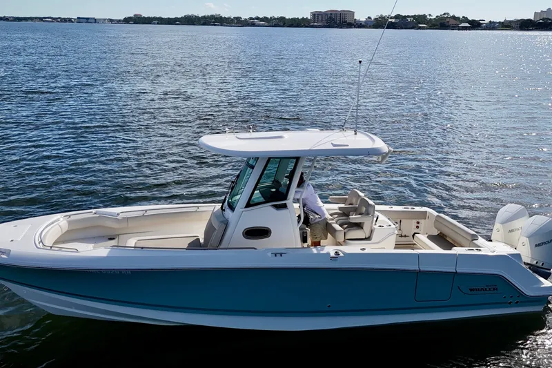 Slide: The Image of 2023 Boston Whaler 280 Outrage boat cruising on a calm lake. - 7