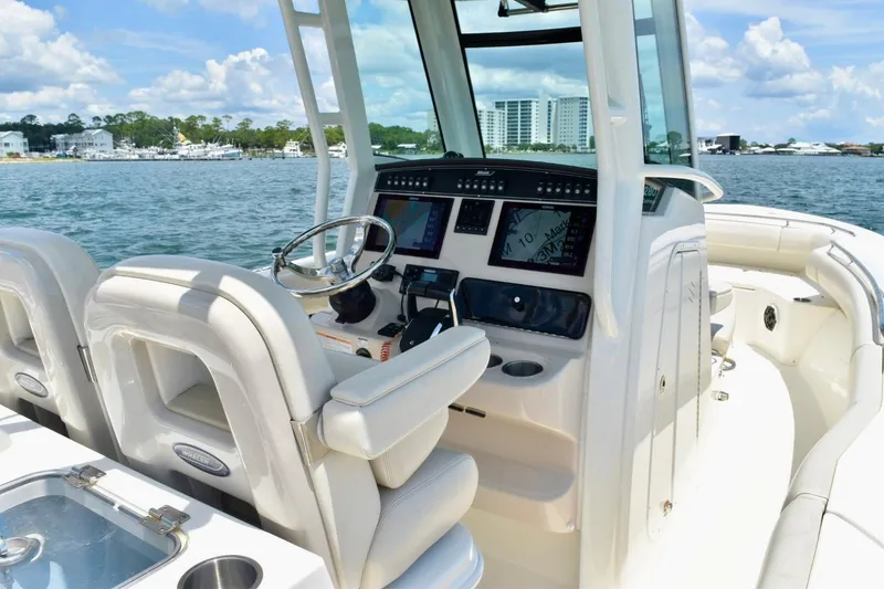 Slide: The Image of 2023 Boston Whaler 280 Outrage boat interior with modern dashboard and steering wheel. - 13